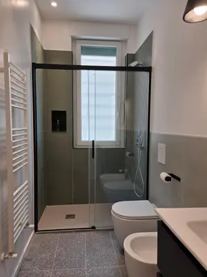 a bathroom with a shower and a toilet and a sink at Maison Viola in Rome