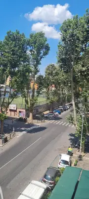 a street with cars parked on the side of a road at Maison Viola in Rome