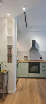 a kitchen with green cabinets and a stove at Maison Viola in Rome