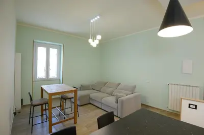 a living room with a couch and a table at Appartamento Iris in Rome