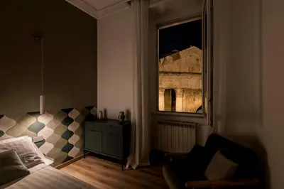 a bedroom with a bed and a window at The Best Rent - Three-Room Apartment with View of the Portico d'Ottavia in Rome