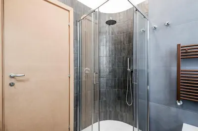 a shower with a glass door in a bathroom at The Best Rent - Three-Room Apartment with View of the Portico d'Ottavia in Rome
