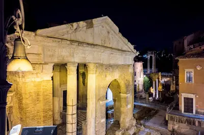 an old building with a bell on the side at The Best Rent - Three-Room Apartment with View of the Portico d'Ottavia in Rome