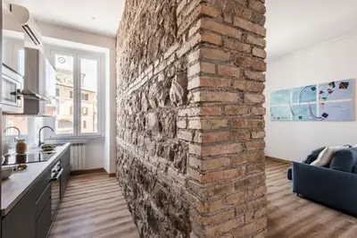 a brick wall in the kitchen of a apartment at The Best Rent - Three-Room Apartment near Lungotevere in Rome