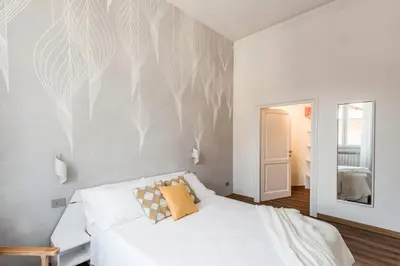 a bedroom with a white bed and a mirror at The Best Rent - Three-Room Apartment near Lungotevere in Rome