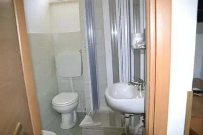 a small bathroom with a toilet and a sink at Aurora Boreale in Rome