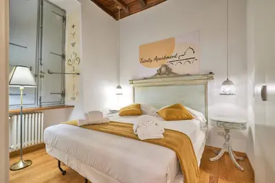 a bedroom with a large white bed with towels on it at Trinity Apartment in Rome