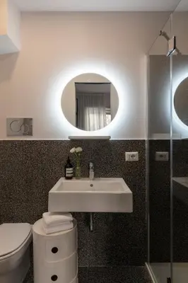 a bathroom with a sink and a toilet and a mirror at MARCANTONIO HOME ROME - Vatican - in Rome