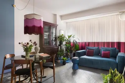 a living room with a blue couch and a table at MARCANTONIO HOME ROME - Vatican - in Rome