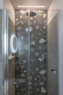 a shower with a glass door in a bathroom at MARCANTONIO HOME ROME - Vatican - in Rome