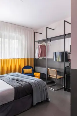 a bedroom with a bed and a pendant light at MARCANTONIO HOME ROME - Vatican - in Rome