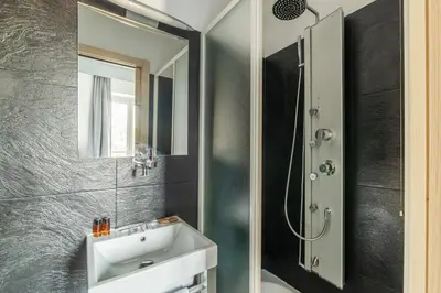 a bathroom with a sink and a shower at San Marco City View Rooms in Rome