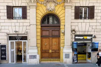 a large wooden door on the side of a building at Casa Vacanze Ottaviano 25 in Rome