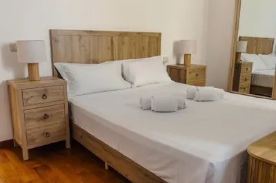 a bedroom with a large white bed with two night stands at Casa Vacanze Ottaviano 25 in Rome