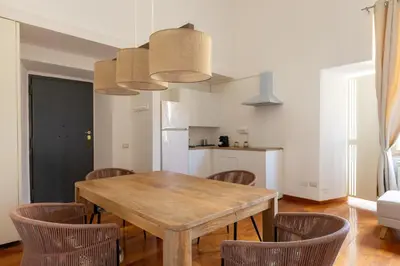 a dining room with a wooden table and chairs at Casa Vacanze Ottaviano 25 in Rome