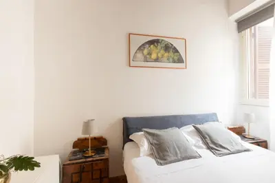 a bedroom with a bed and a picture on the wall at 346aarome Rome Vaccarella Terrace in Rome