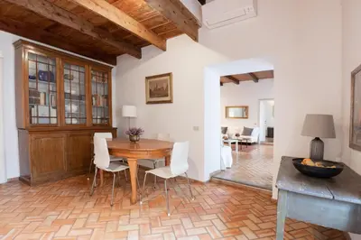 a dining room with a wooden table and white chairs at 346aarome Rome Vaccarella Terrace in Rome