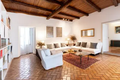 a living room with white furniture and a wooden ceiling at 346aarome Rome Vaccarella Terrace in Rome