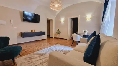 a living room with a couch and a table at Cozy Colosseum 2BR-2BA Family Home in Rome