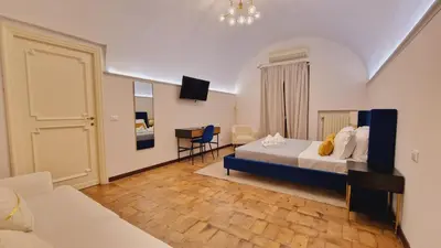 a bedroom with a bed and a desk in it at Cozy Colosseum 2BR-2BA Family Home in Rome