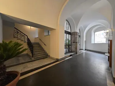 an empty hallway with a staircase in a building at Cozy Colosseum 2BR-2BA Family Home in Rome