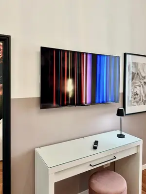 a white desk with a chair and a monitor on a wall at Vacanze Romane Suite 7 Languages in Rome