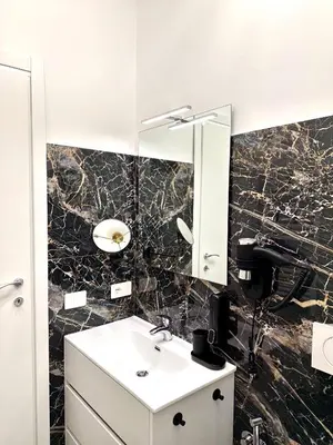 a bathroom with a sink and a mirror at Vacanze Romane Suite 7 Languages in Rome