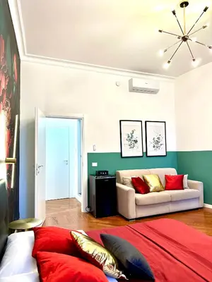 a living room with a bed and a couch at Vacanze Romane Suite 7 Languages in Rome