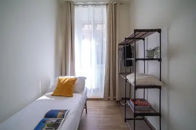 a living room with a couch and a book shelf at New 3BR-2 Baths Near Vatican & Metro- The Comics House in Rome