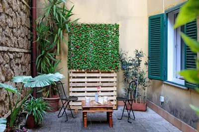 a patio with a table and chairs next to a building at Charming Nest Steps from the Vatican in Rome