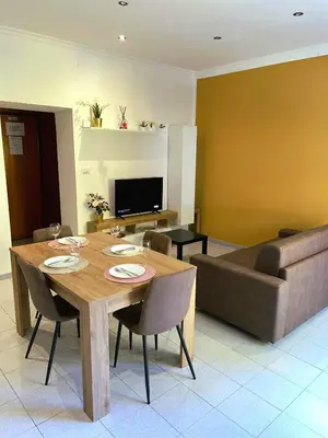 a dining room with a table and a couch at Cielo Aperto Bed and Breakfast in Rome