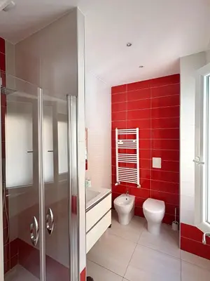 a red bathroom with a toilet and a sink at Fortis Domus in Rome