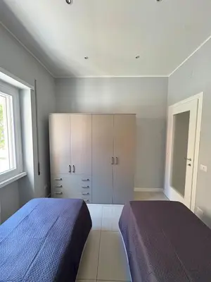 a bedroom with a bed and cabinets and a window at Fortis Domus in Rome