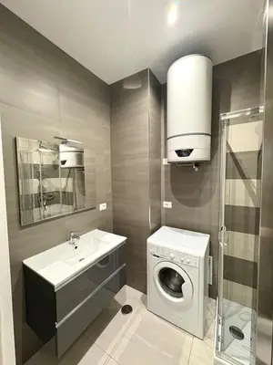 a bathroom with a washing machine and a sink at Fortis Domus in Rome