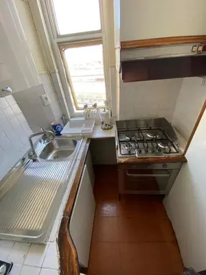 a small kitchen with a sink and a stove at Casa Vacanze Domus 46 in Rome