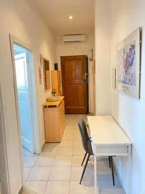 a room with a desk and a table and a door at Casa Vacanze Domus 46 in Rome