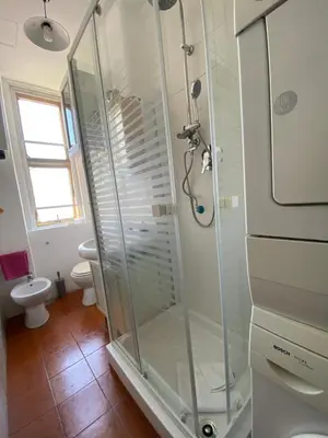 a glass shower in a bathroom with a toilet at Casa Vacanze Domus 46 in Rome