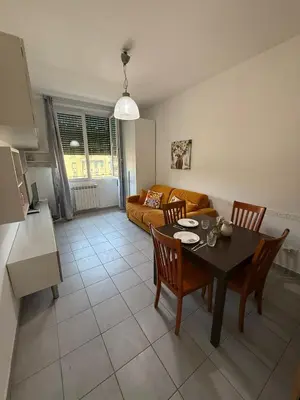a living room with a table and chairs and a couch at Casa Vacanze Domus 46 in Rome