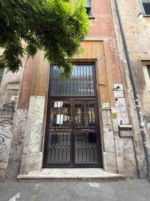 a door on the side of a building with graffiti at Casa Vacanze Domus 46 in Rome