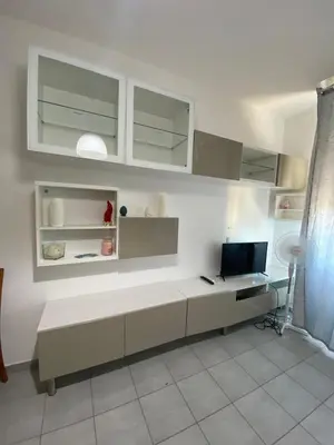 a white room with a desk and a television at Casa Vacanze Domus 46 in Rome