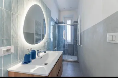a living room with a couch and a table at Colosseum Apartment, 3 bedrooms, 3 baths, large living room with a sofa bed, the apartment can accommodate 8 people in Rome