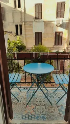 a blue table and chairs on a balcony at Colosseum Apartment, 3 bedrooms, 3 baths, large living room with a sofa bed, the apartment can accommodate 8 people in Rome
