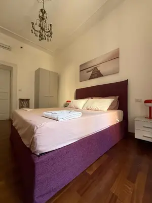 a small bedroom with a bed and a window at Colosseum Apartment, 3 bedrooms, 3 baths, large living room with a sofa bed, the apartment can accommodate 8 people in Rome