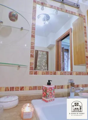 a bathroom with a sink and a mirror at A Casa di Mary in Rome
