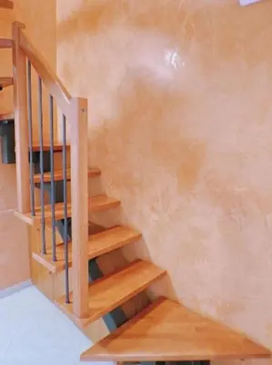 a wooden staircase in a room with a wall at A Casa di Mary in Rome