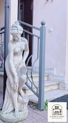a statue of a woman sitting on a rock at A Casa di Mary in Rome