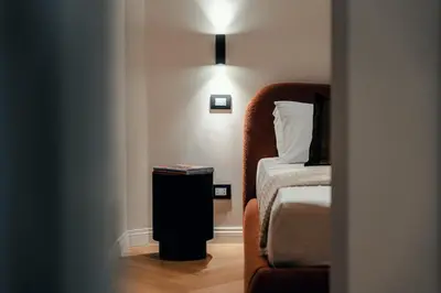 a small room with a bed and a nightstand next to a bed at The Rubens Spagna in Rome