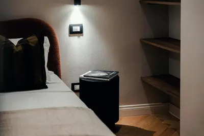 a small room with a bed and a nightstand next to a bed sidx sidx at The Rubens Spagna in Rome