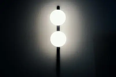 two lights on a wall in a room at The Rubens Spagna in Rome