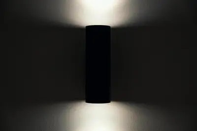 a black vase in a dark room with a light at The Rubens Spagna in Rome